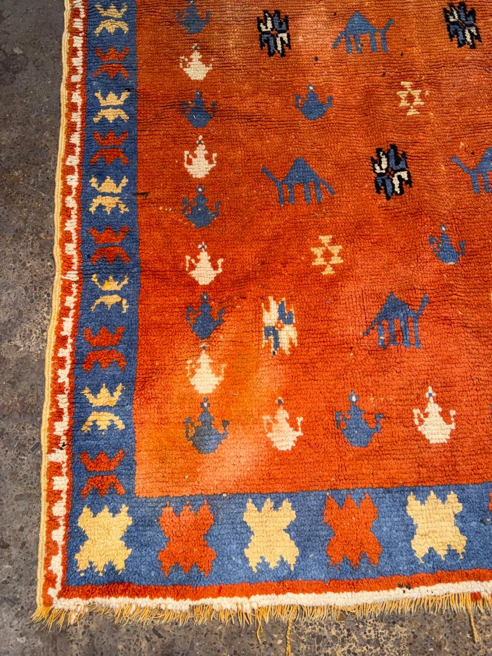 abstract tribal symbols on antique Moroccan wool rug