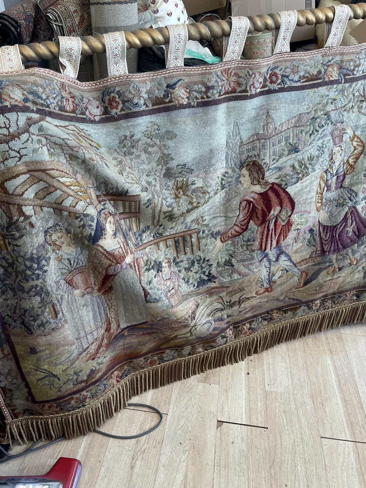 Angled front view showing landscape, floral border and hanging loops