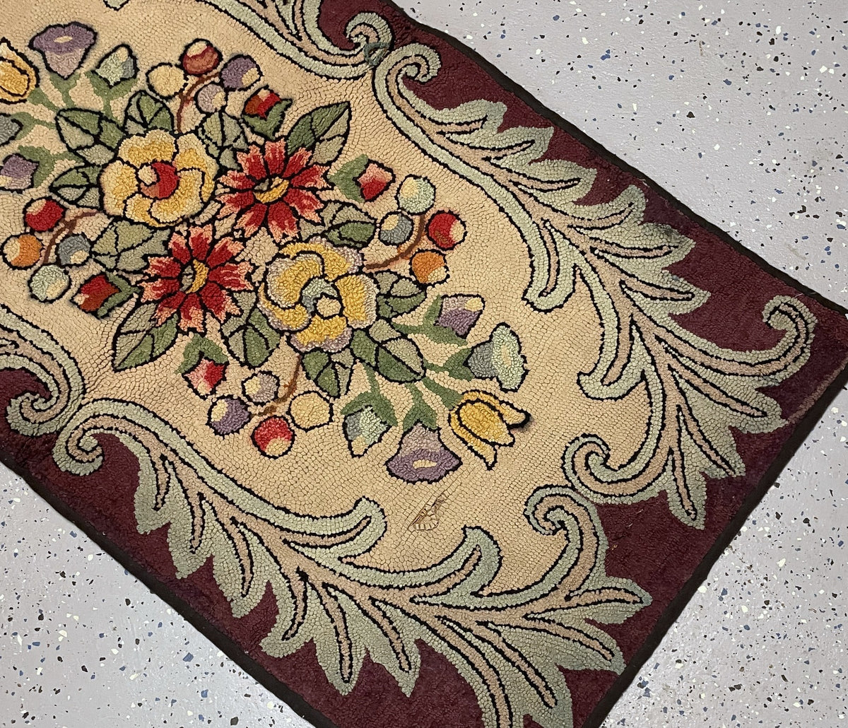 Close view of the floral arrangement and elongated area of missing loops exposing foundation near one end.