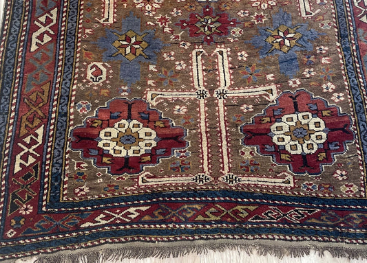 Late 19th century tribal rug from Shirvan district with tobacco brown field and madder red medallions on floor