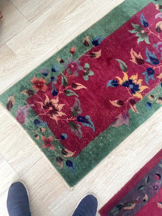 Vintage Nichols style rug from China with deep violet-purple ground and asymmetrical floral design on floor