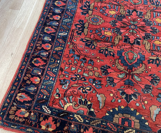 Early 20th century Armenian-Persian village rug from Hamadan region with soft earthy salmon-pink ground on floor