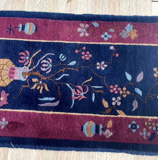 Vintage Nichols style scatter rug from Peking Tientsin region with midnight navy ground and canary yellow coral rose blossoms on floor
