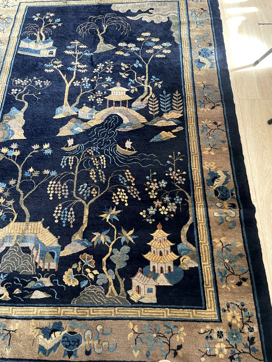 Early 20th century Chinese rug from Peking with deep indigo field and soft cream pictorial motifs on floor