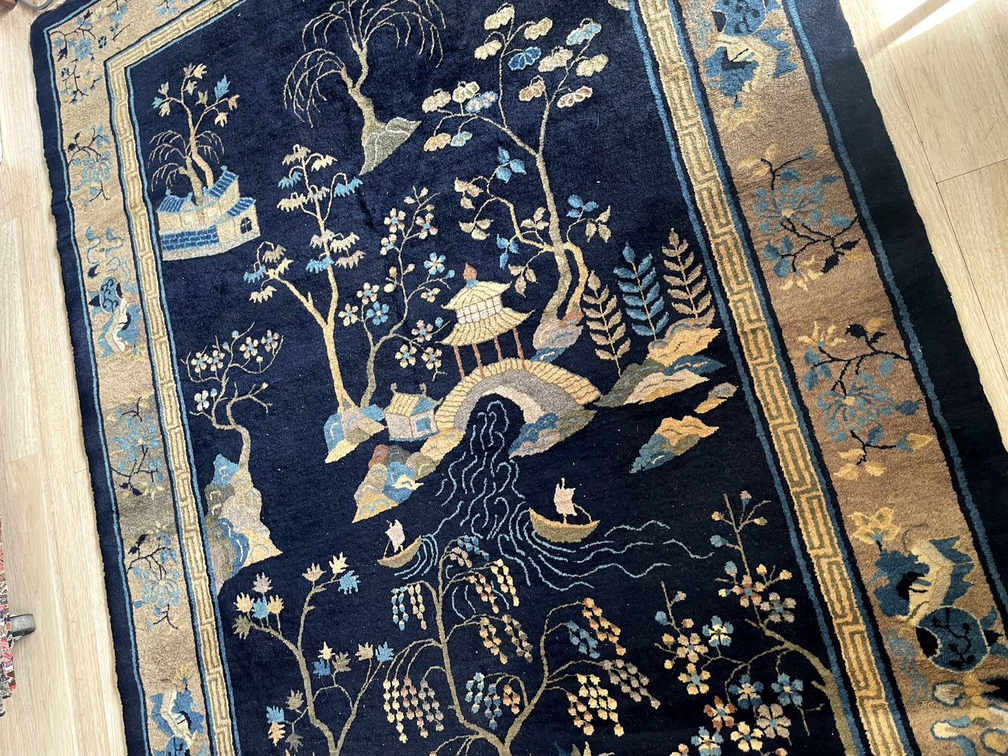 Detail of indigo and cream color contrast with antique gold accents in traditional Chinese motif arrangement