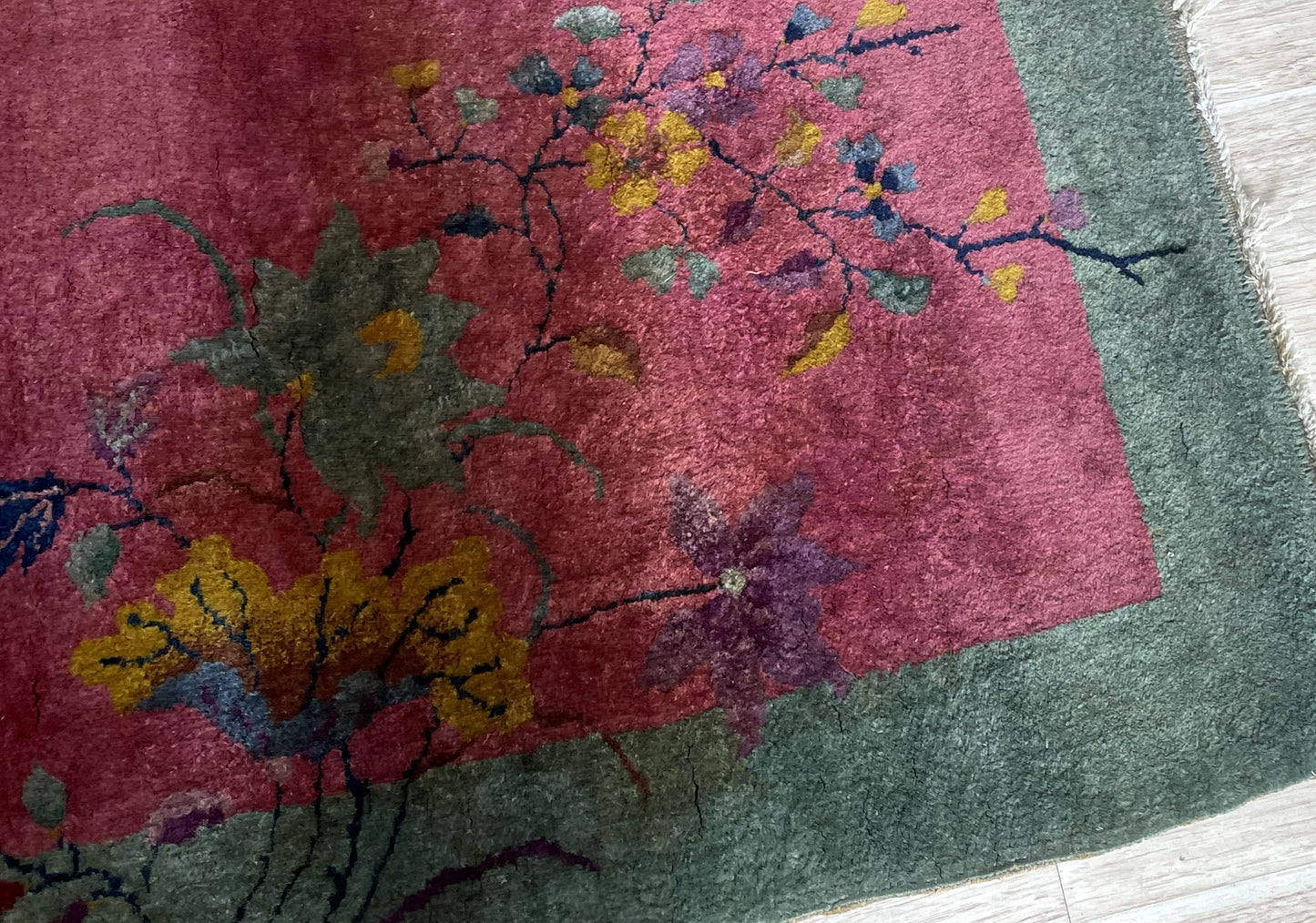 Elegant minimalist design featuring singular floating floral spray or stylized corner motif against deep lustrous field