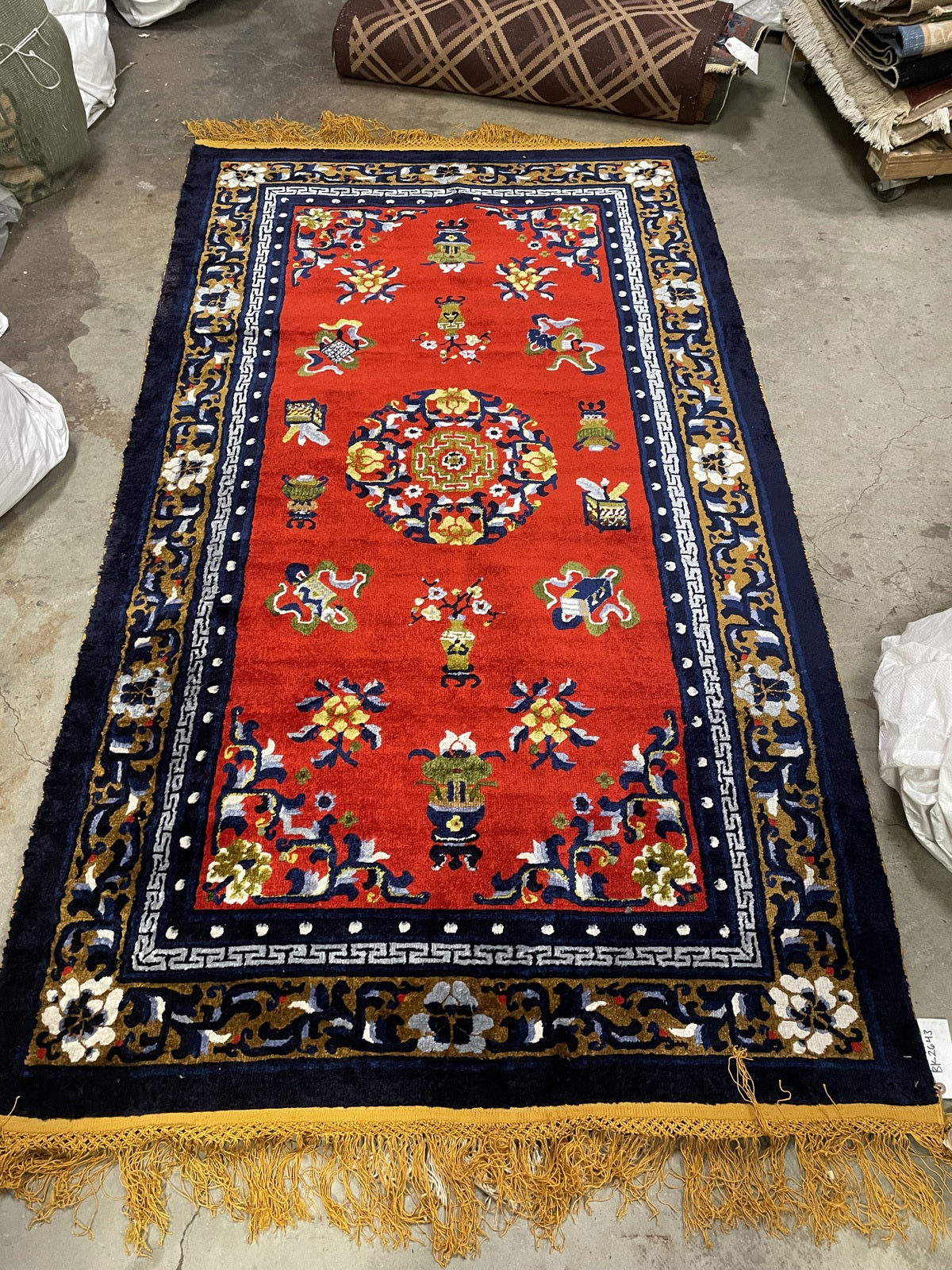 Chinese Art Deco silk rug detail, stylized flowers and vibrant red background