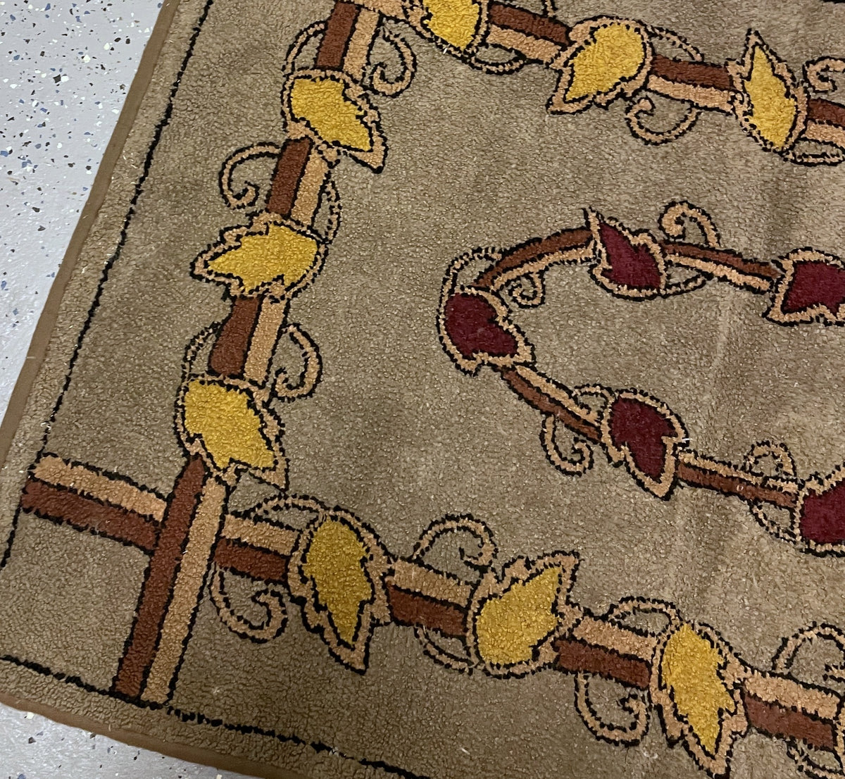 Bound corner showing intersecting trellis bands and slightly irregular rug edges.