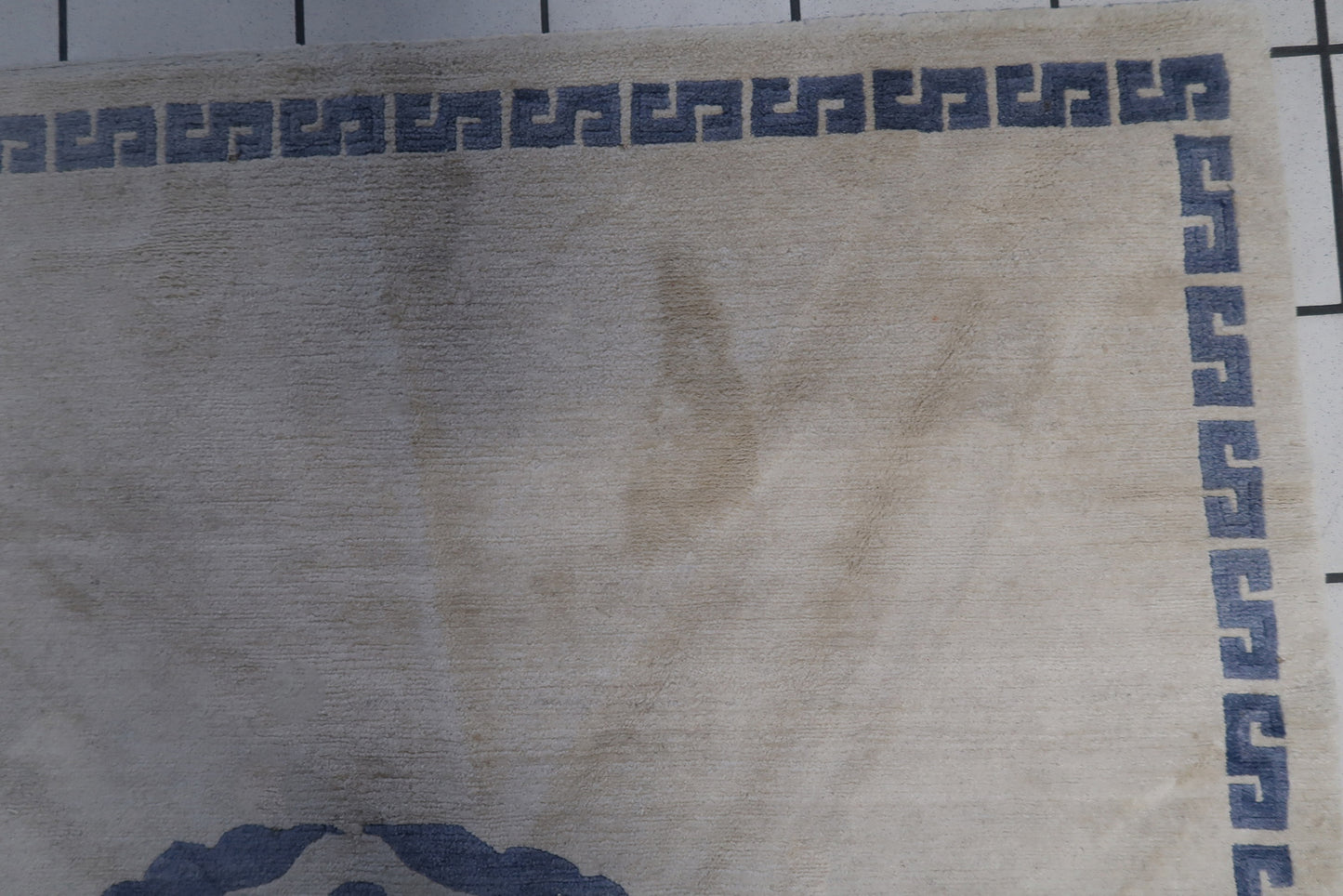 Close-up of the circle medallion with dragon motif on the handmade vintage Tibetan Khaden rug
