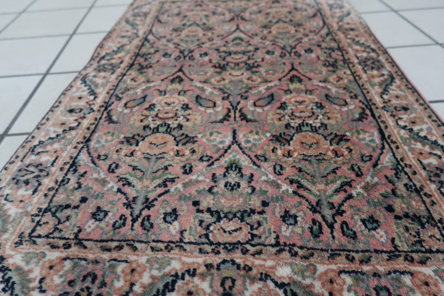 Detailed shot highlighting the turquoise geometric patterns and artistic flair of the rug.