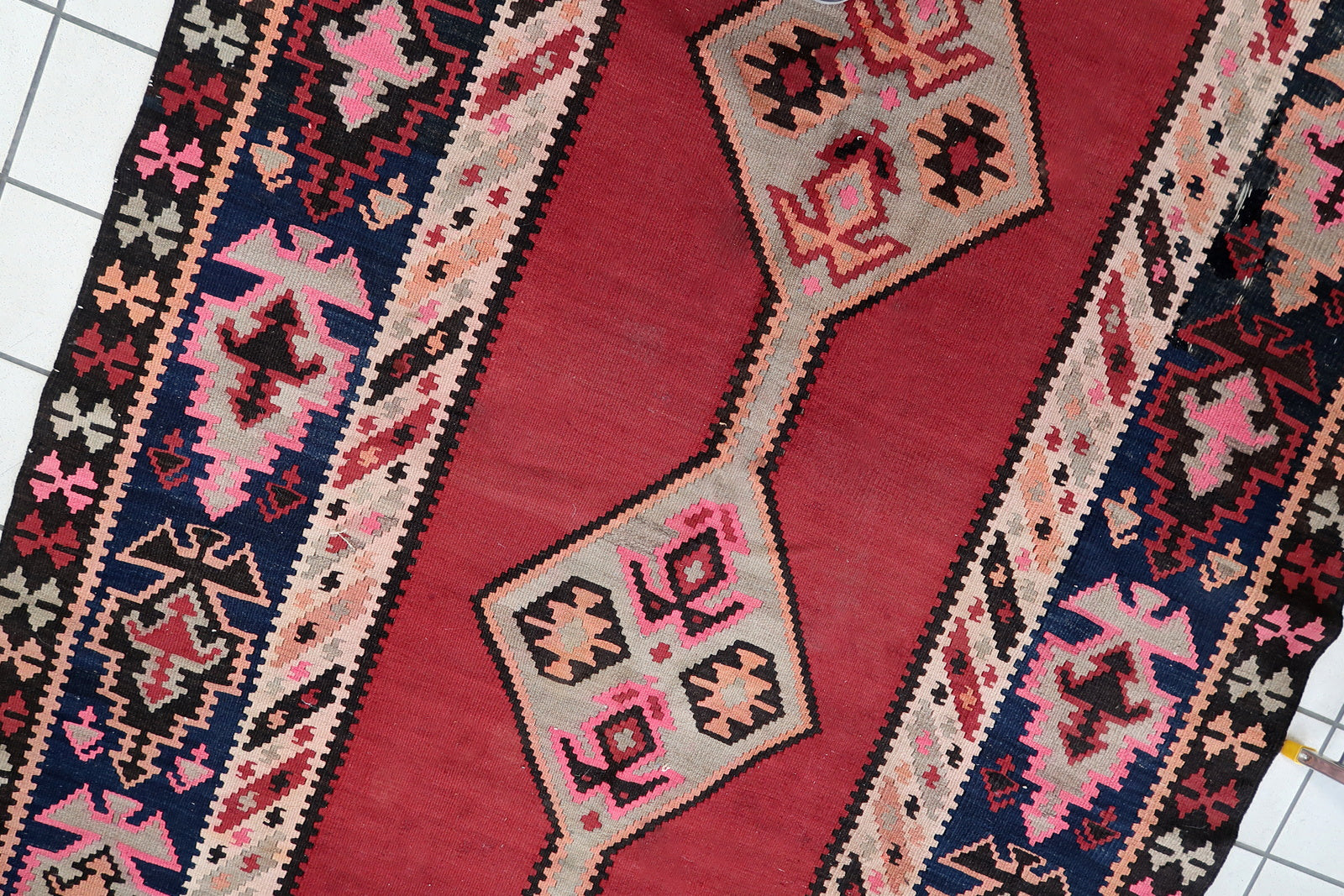 Vibrant Patterns in Red and Brown on Vintage Kilim