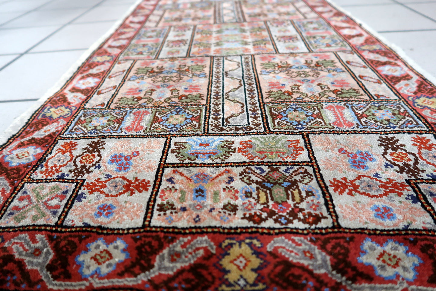 Artistic display of the Tunisian silk rug as a statement piece in a cozy living room
