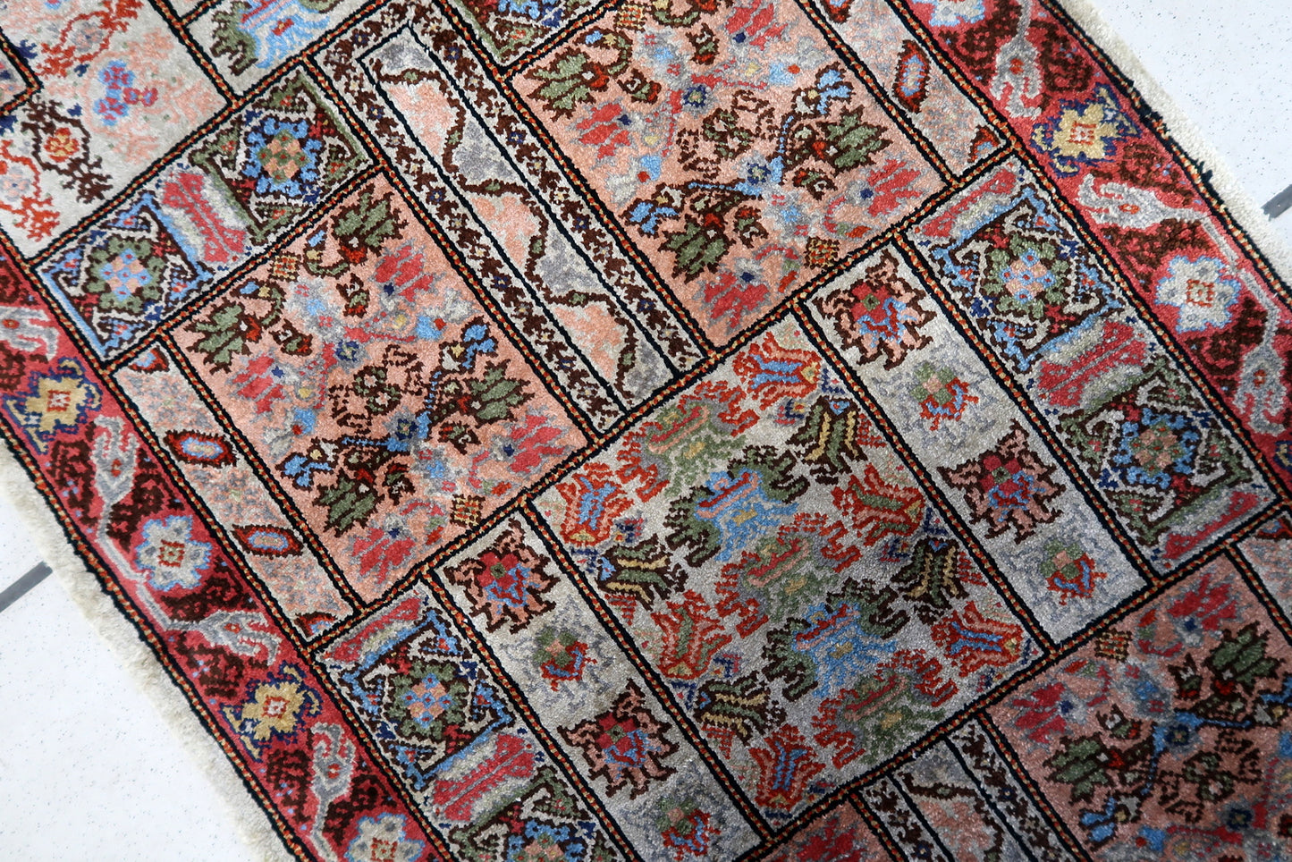 Side view of the small rectangular rug made from luxurious silk fibers