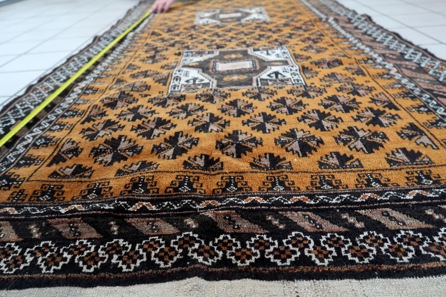 Close-up of the rug's corner, showcasing the intricate craftsmanship and knotting techniques