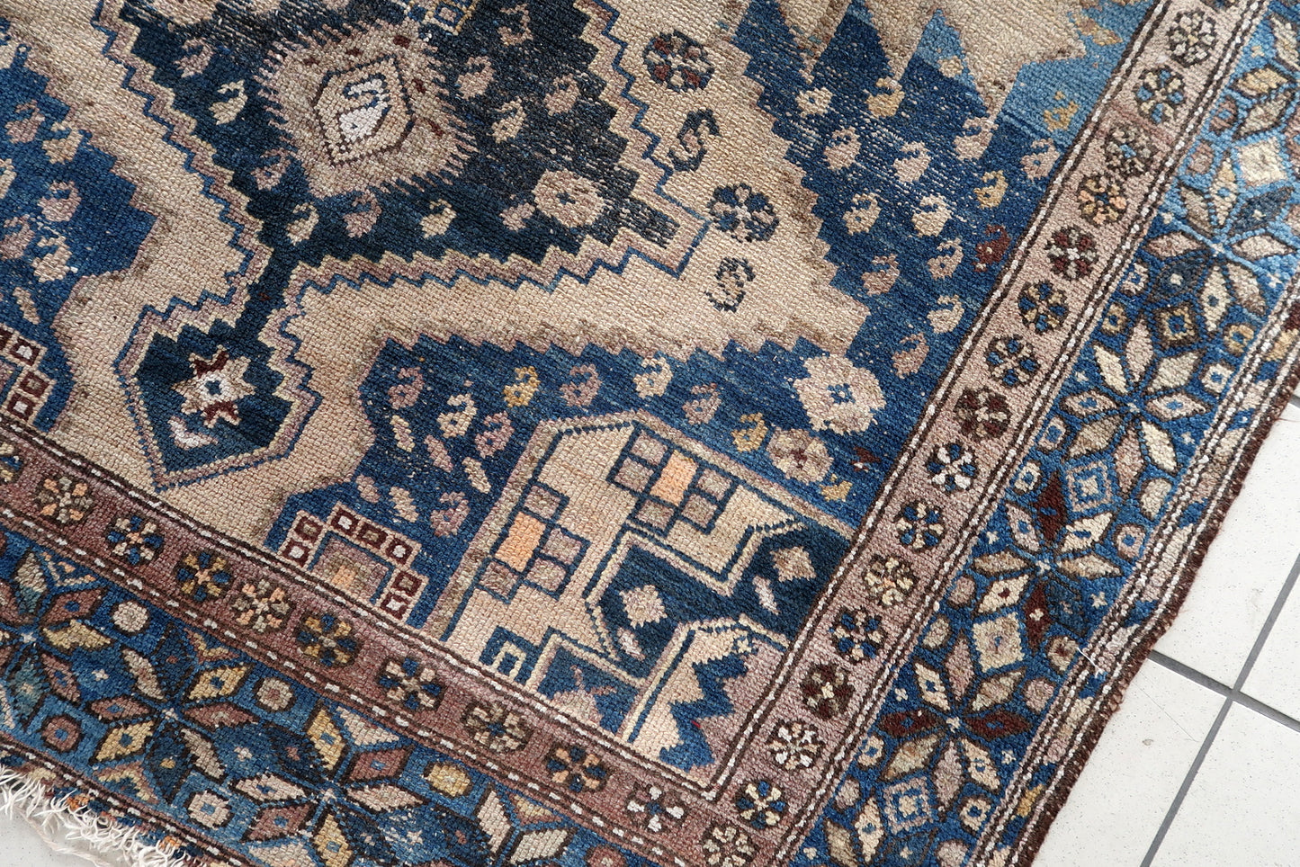 Close-up of cozy living room setting with Handmade Antique Caucasian Shirvan Rug - Detailed view showing the rug enhancing the warmth of a cozy living room.