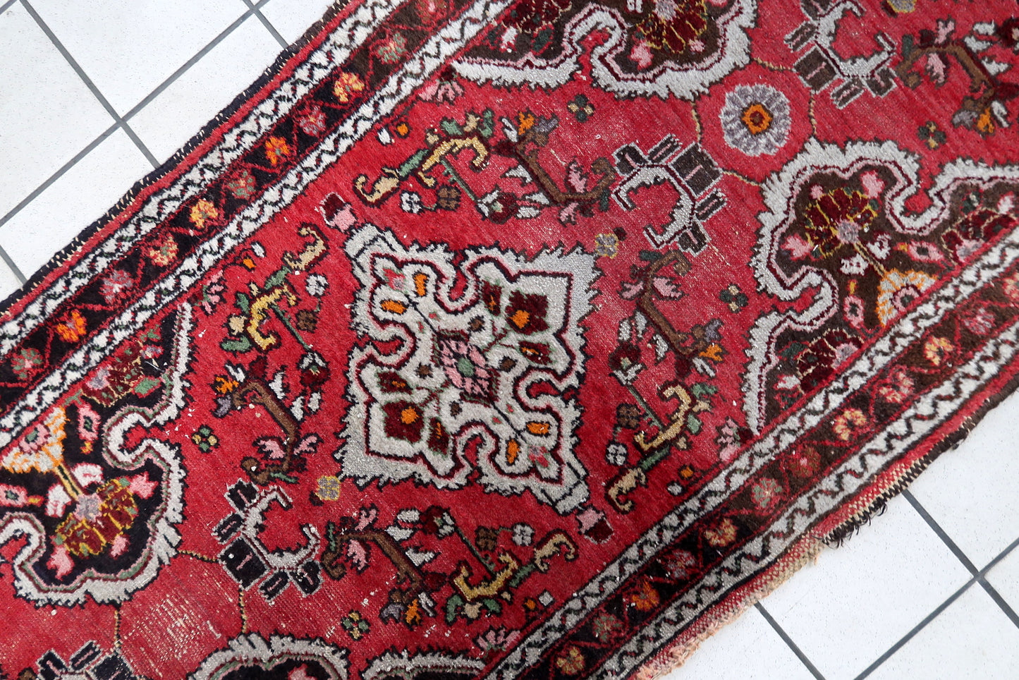 Boteh-inspired motifs on vintage Malayer runner