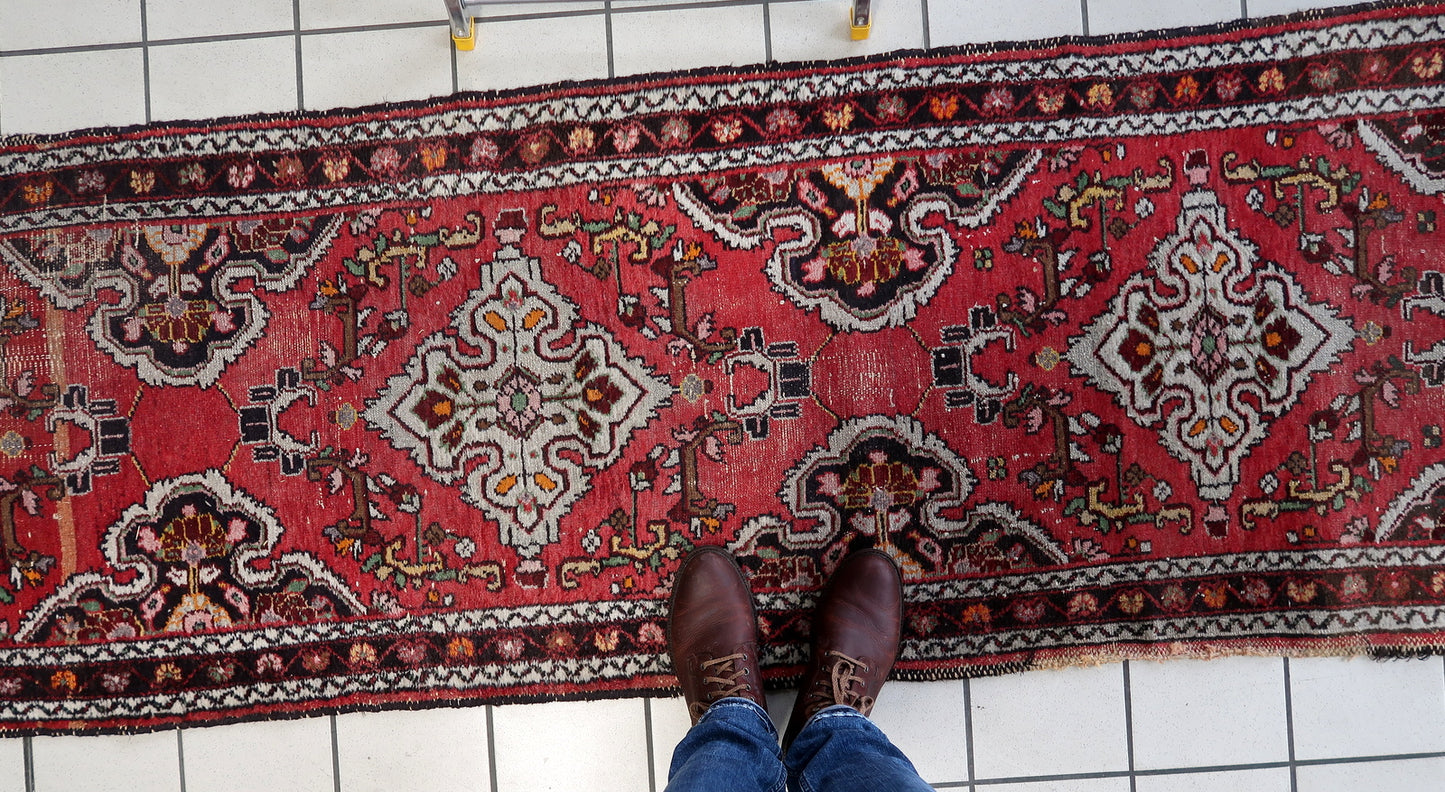 Repeating floral and geometric forms along rug length