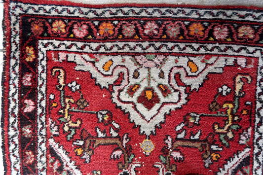 Close-up of a red patterned rug with intricate designs