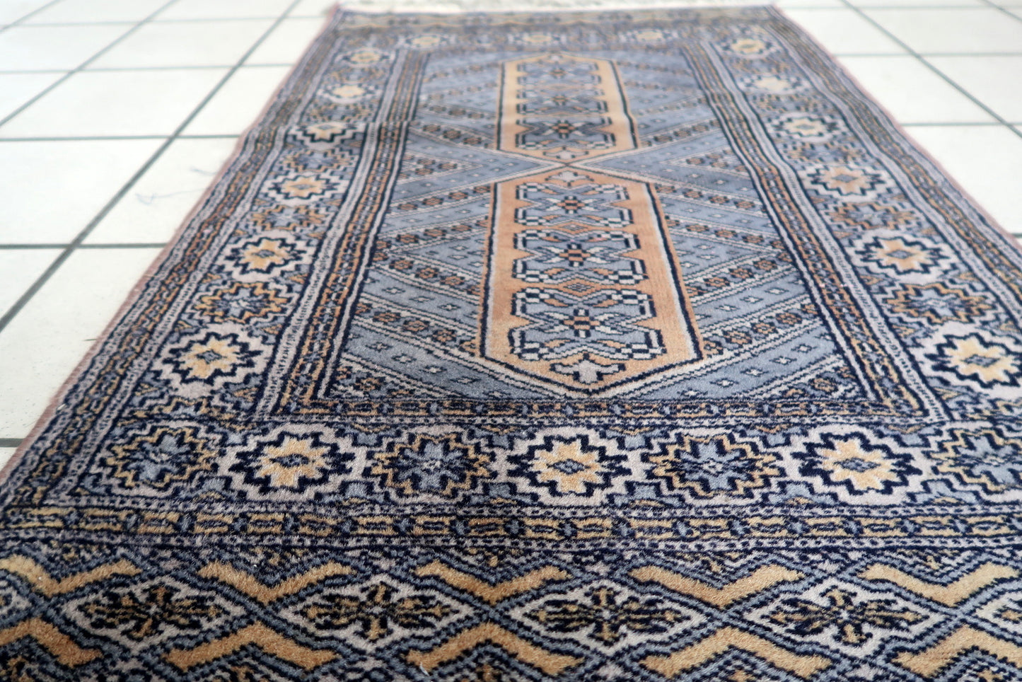 Compact tribal rug with symbolic layout