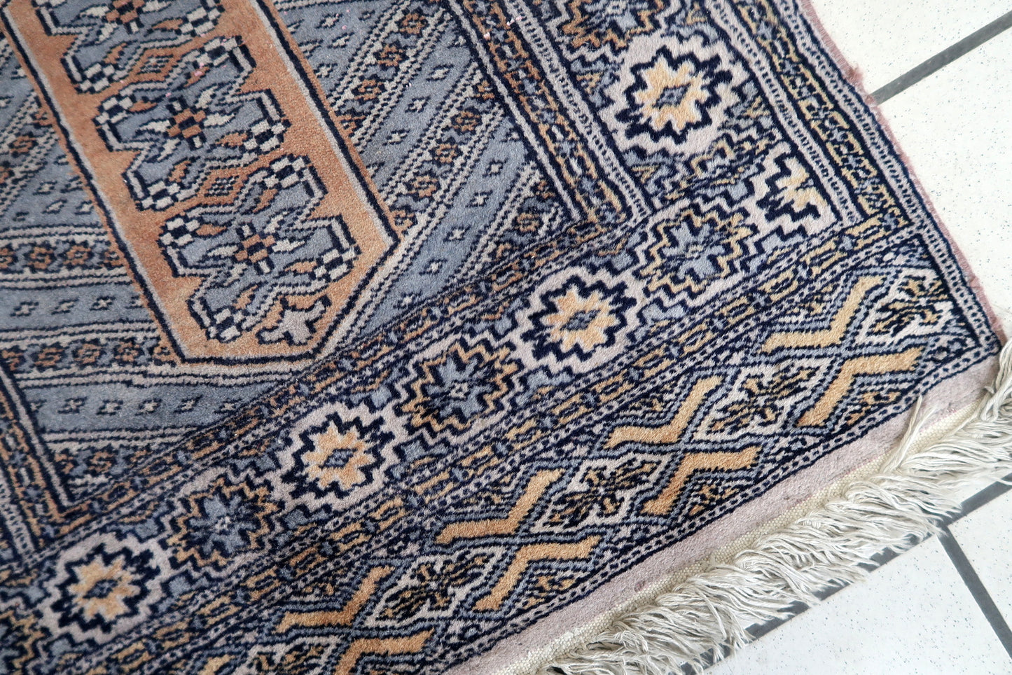 Multiple border patterns on vintage Uzbek rug