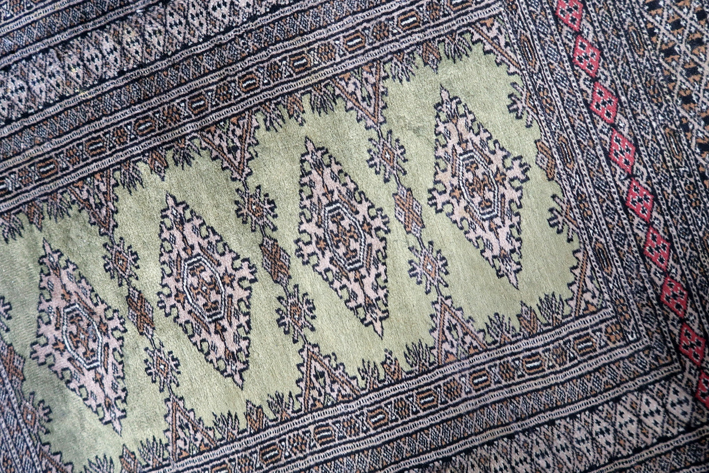 Central Asian rug in deep red and ivory tones