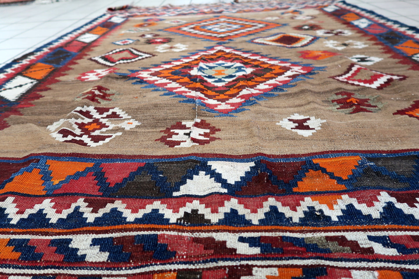 Wool kilim rug with symbolic tribal patterns