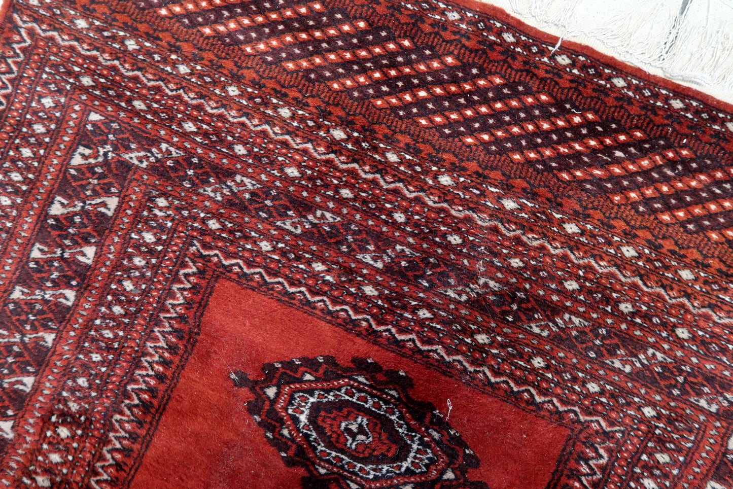 Repeating geometric guls on vintage Bukhara rug