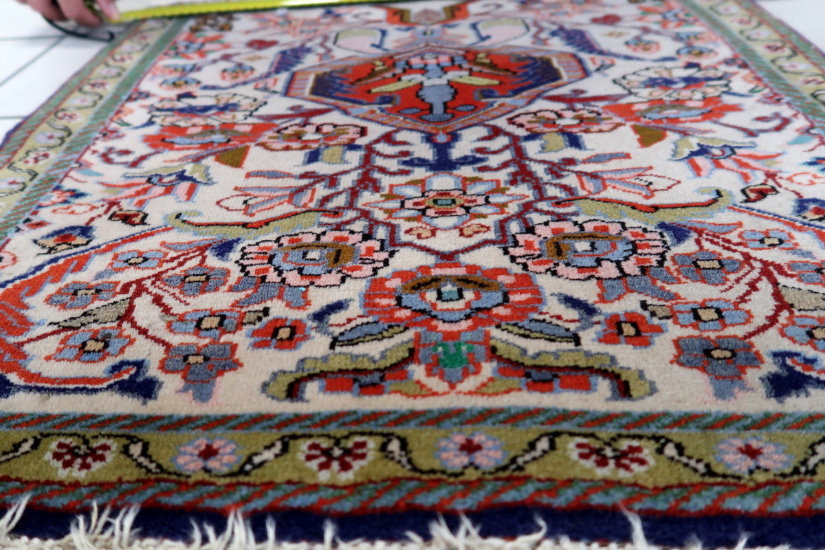 A detailed shot of the rug’s fringe, showing natural aging