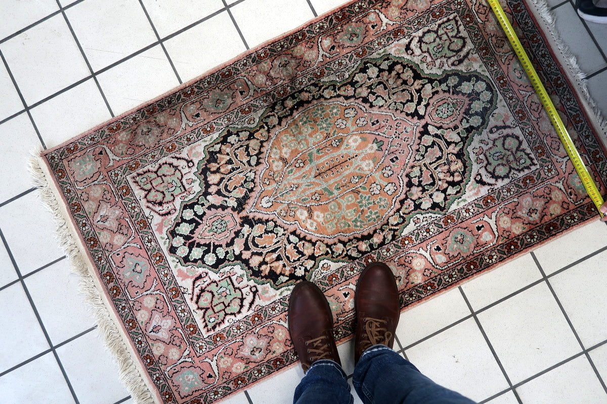 The rug placed in an entryway, adding vintage charm to the space