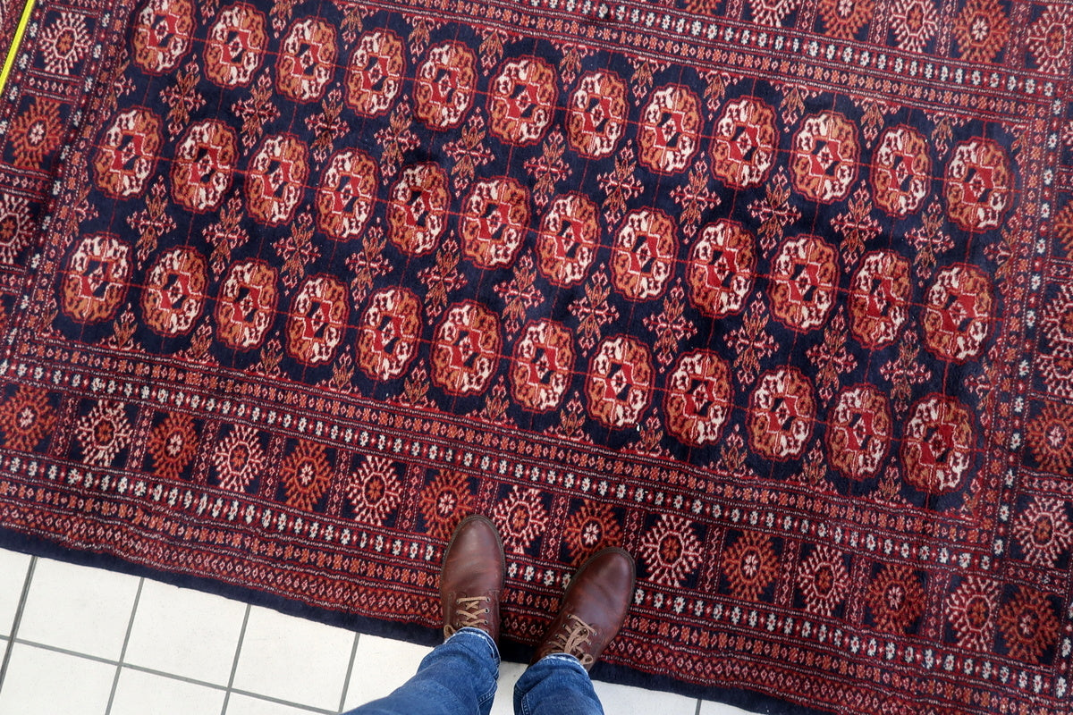 The rug layered over a larger Persian carpet, for a stylish interior look