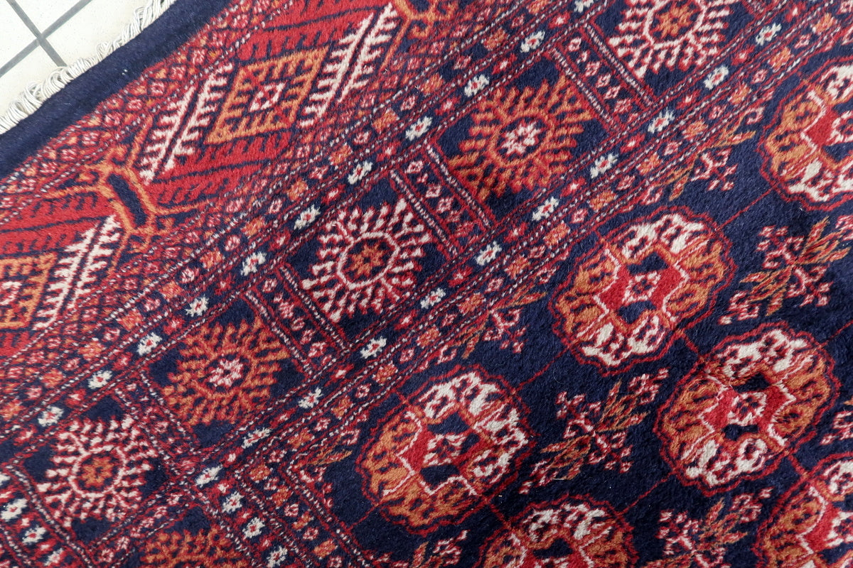 The rectangular Bukhara rug laid flat, showcasing intricate geometric details