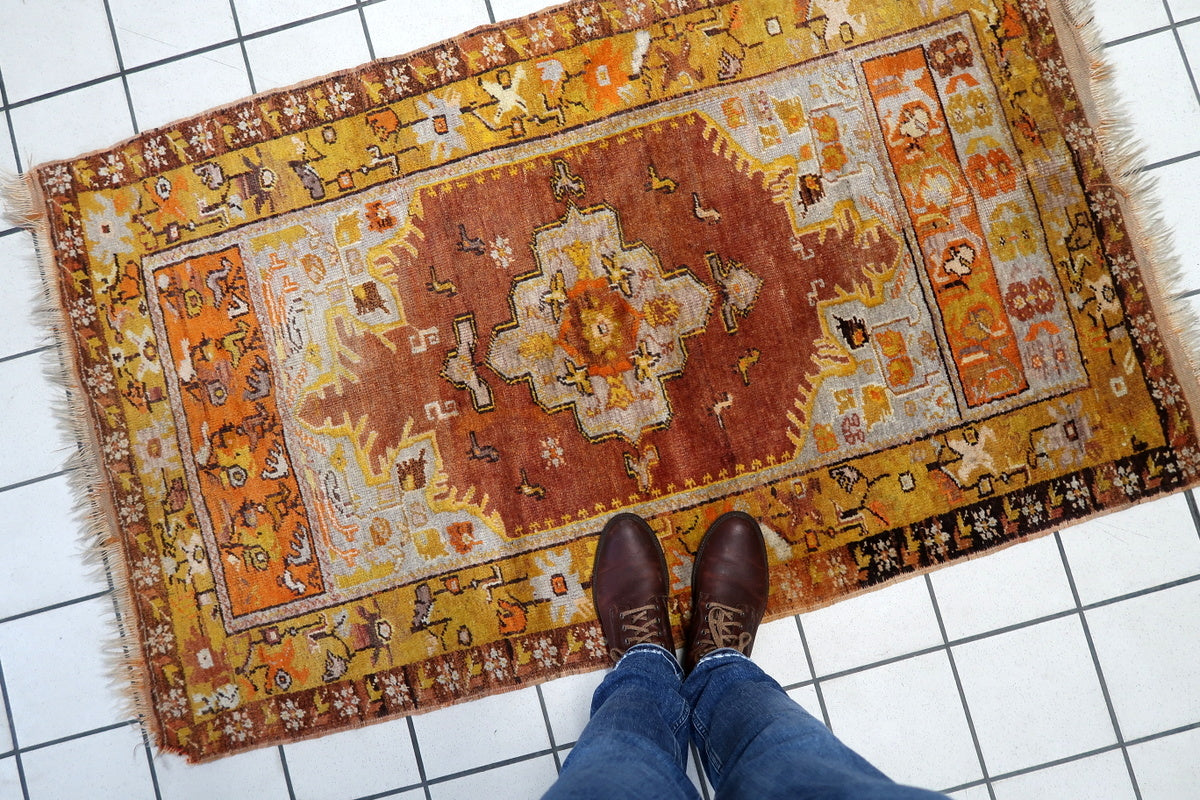 Close-up of the rug’s intricate border design and fine weaving technique