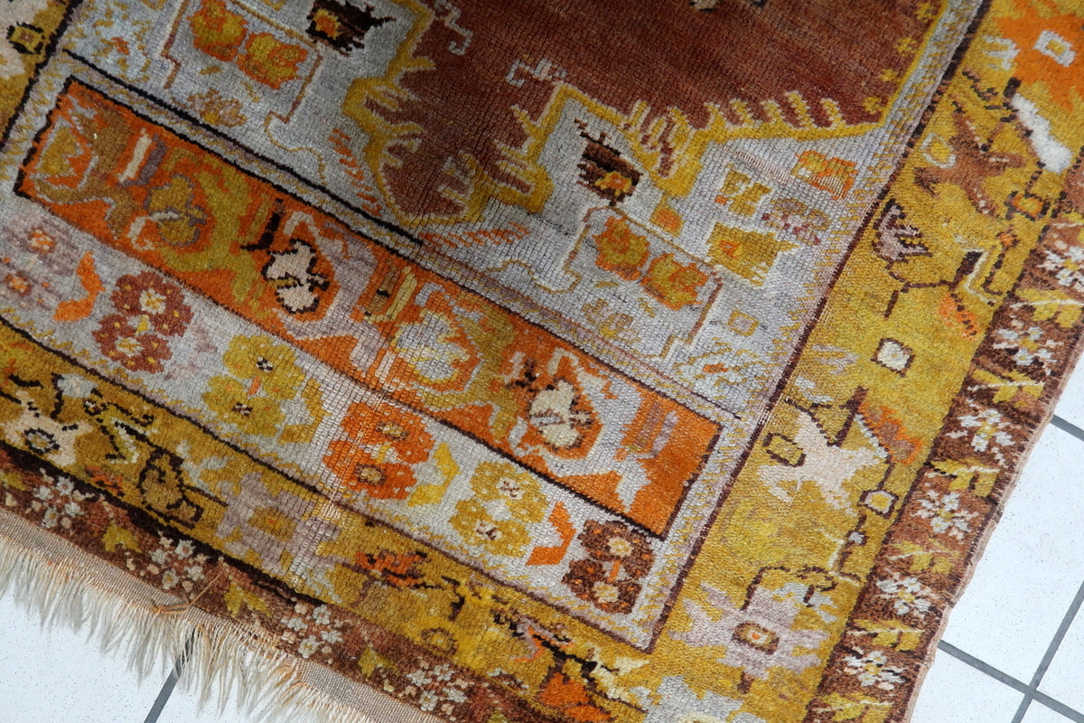 Detailed view of the geometric and floral motifs on the vintage Turkish carpet