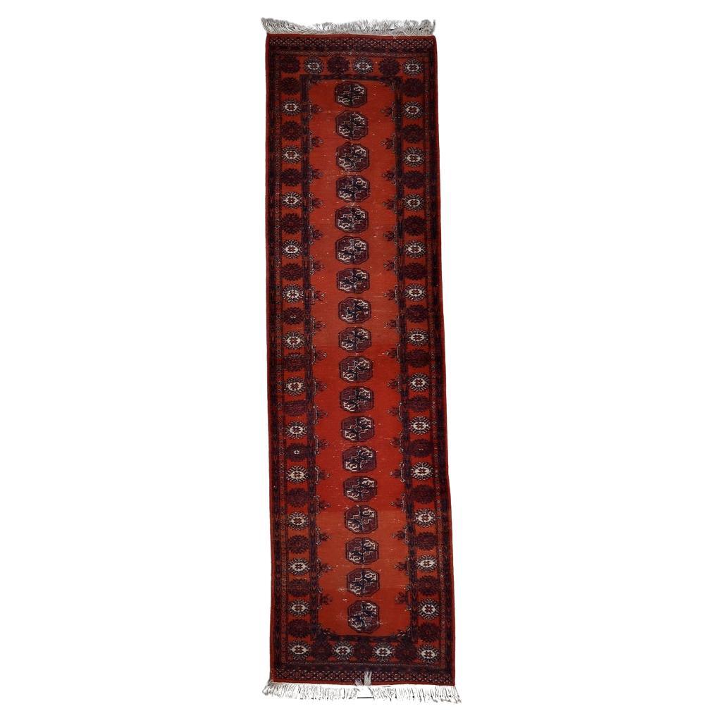 Handmade vintage 1950s Uzbek Bukhara runner rug with red, blue, and white tribal motifs