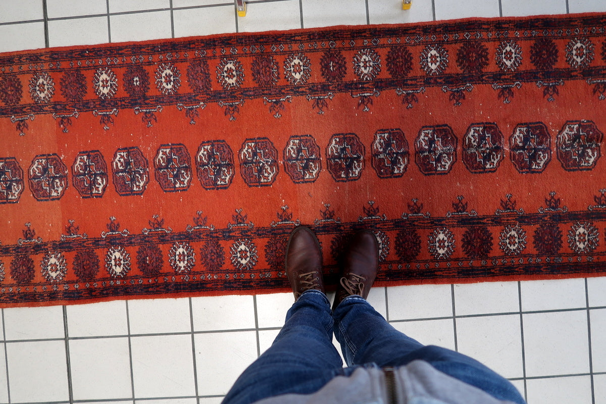 Antique rug’s classic octagonal motifs, reflecting the artistry of Uzbek weavers