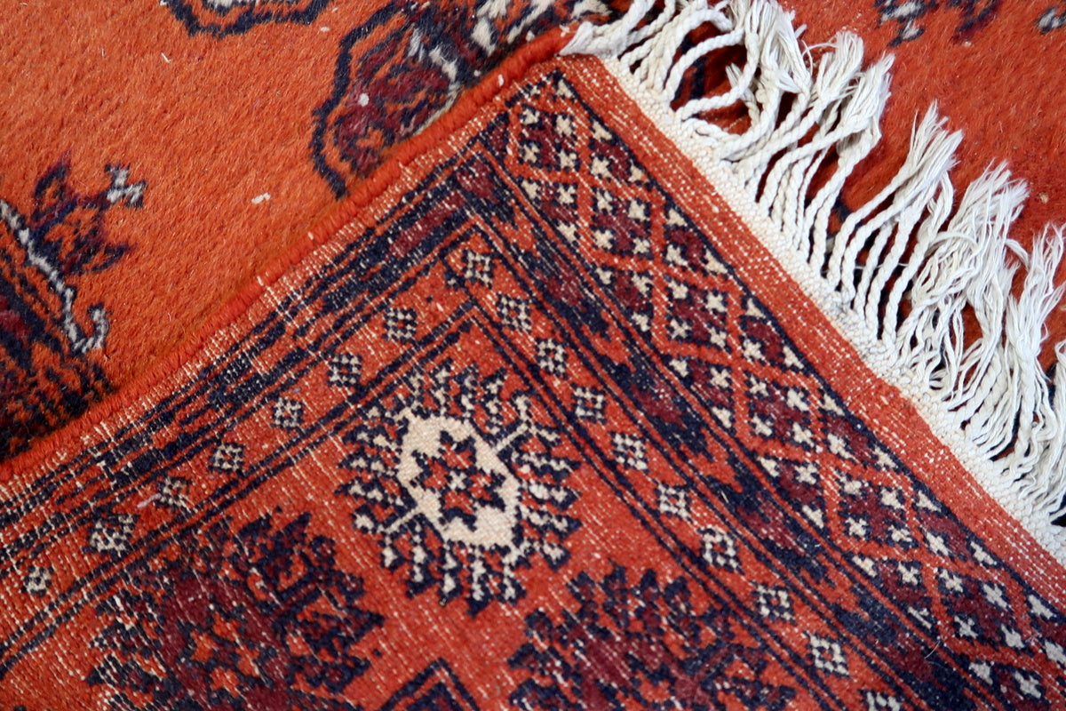 Aged patina of the vintage wool runner, enhancing its authentic appeal
