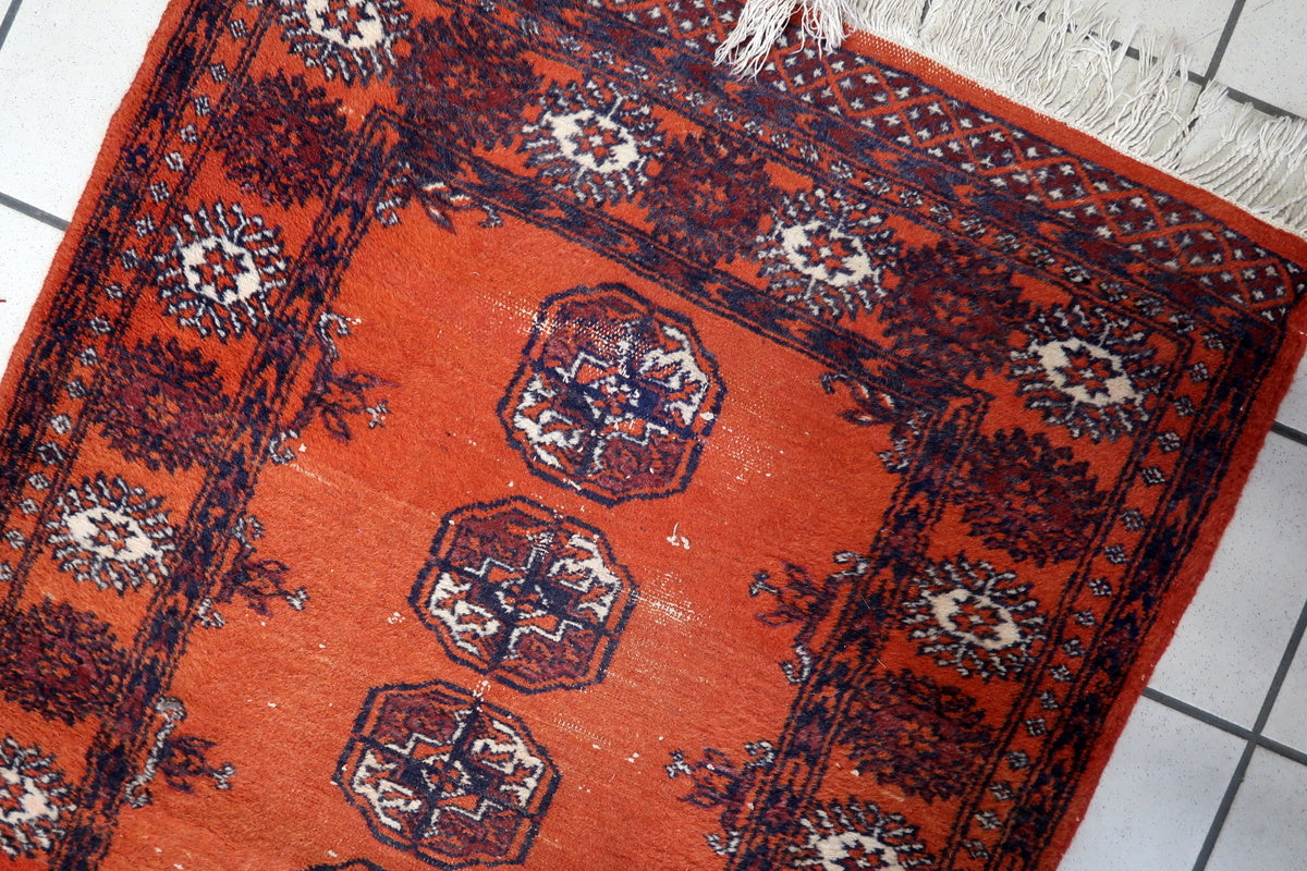 Close-up of the geometric octagonal medallions on the vintage Bukhara runner