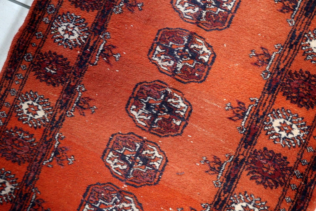Low pile texture of the antique Bukhara rug, adding to its refined aesthetic