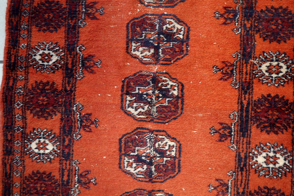 Handwoven wool fibers of the 1950s Uzbek rug, highlighting its durability