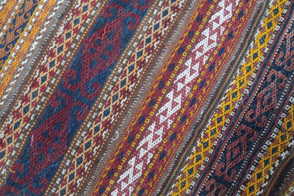 Handwoven Moroccan Kilim laid out as a statement piece in a vintage-style living space