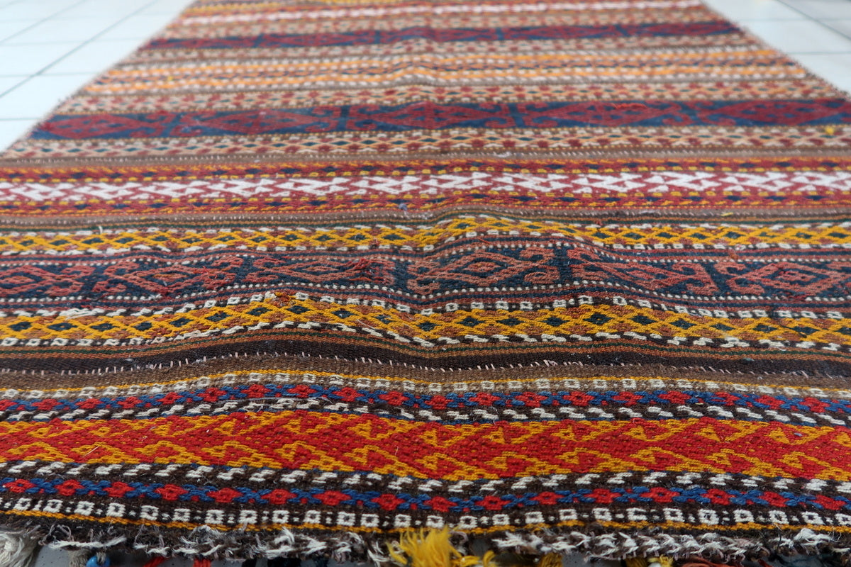 Colorful Moroccan Kilim used as a stunning wall hanging in a rustic home setting