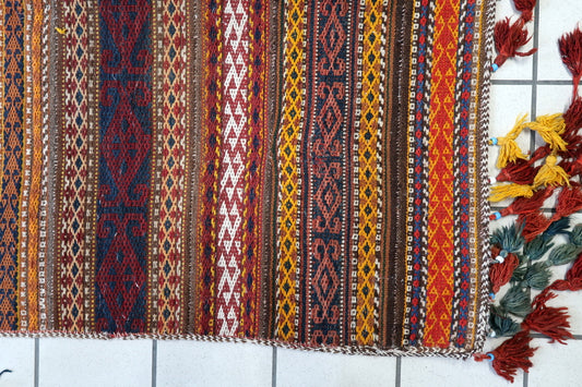 Close-up of intricate traditional Berber patterns on a 1930s Moroccan wool Kilim