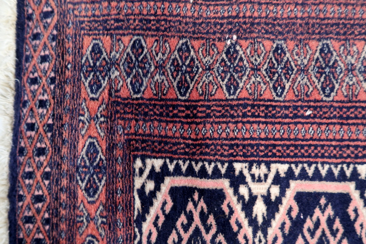 Fringed edges of the handwoven Uzbek rug, showcasing traditional craftsmanship