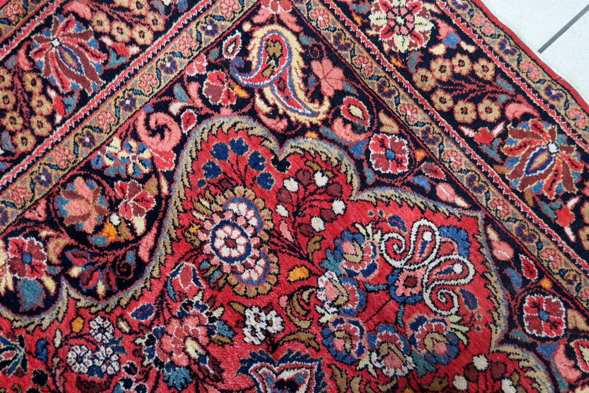 Side view of the rug on the floor showing the vintage wear and aging of the fabric