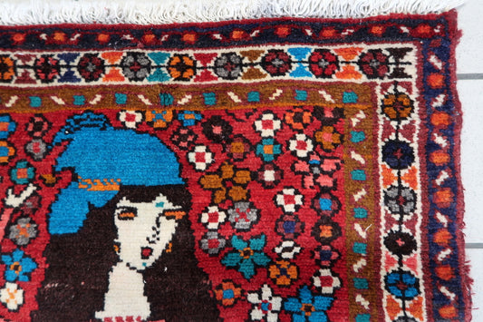 Vintage Persian rug with intricate floral motifs and bold colors
