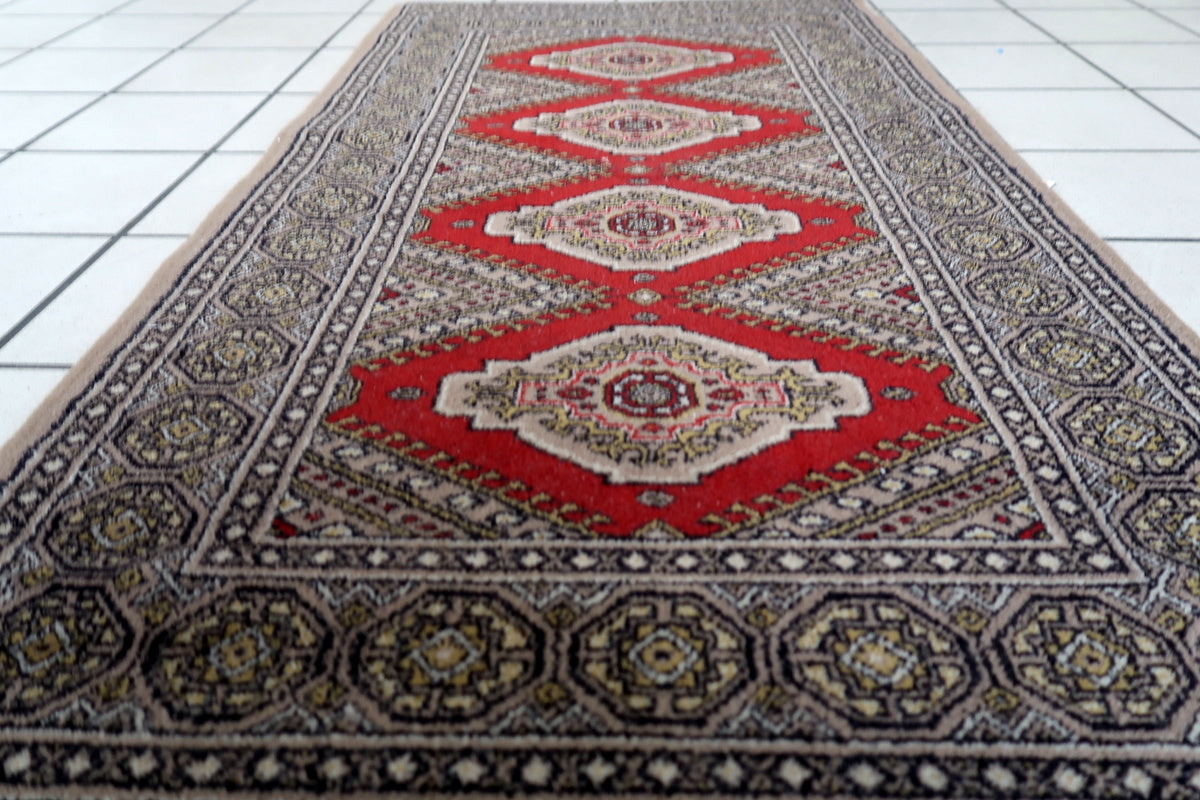 Mid-century modern rug featuring warm red tones and geometric designs