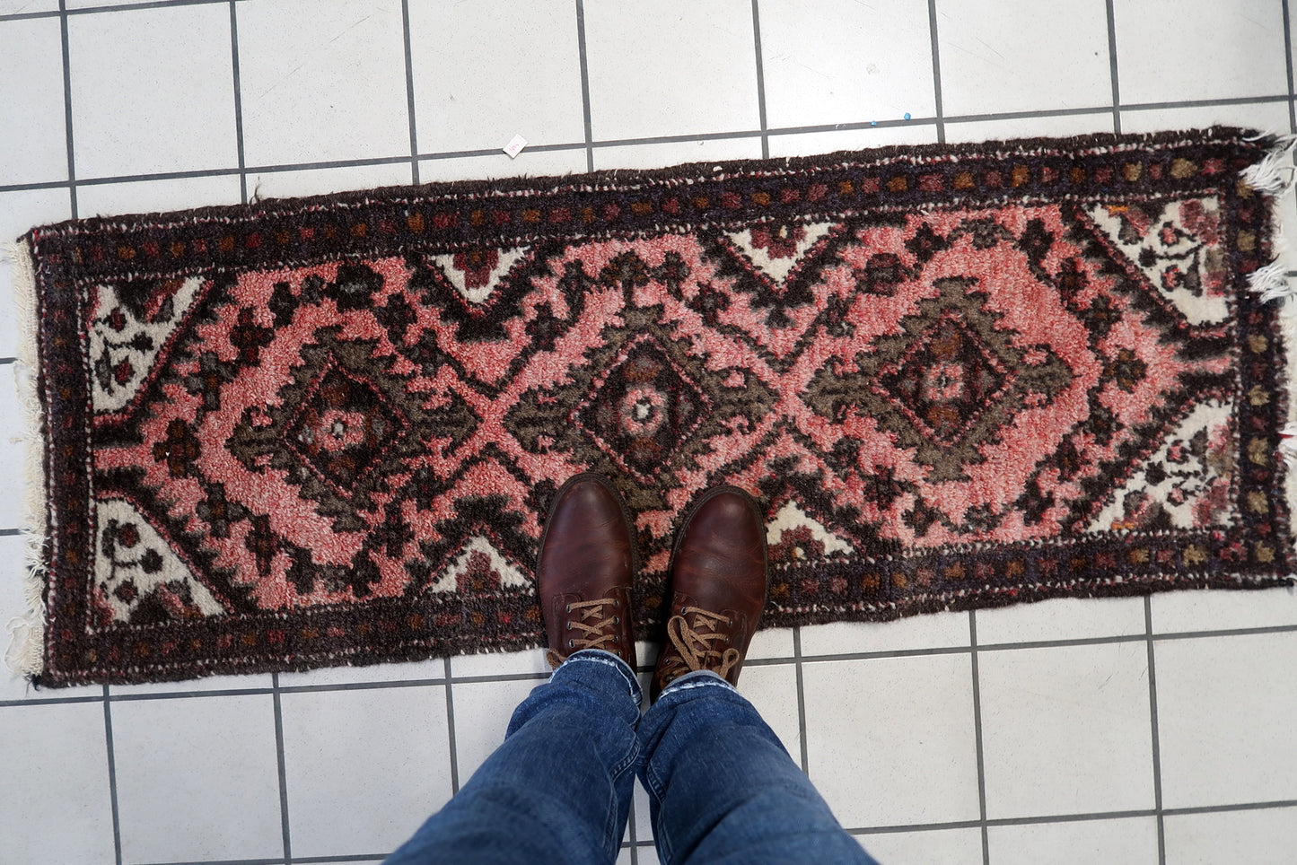 Detailed border of a vintage wool runner rug with traditional Uzbek motifs