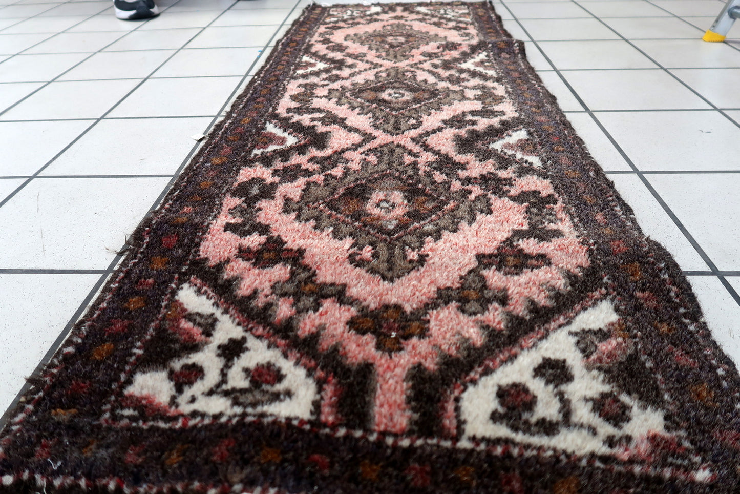 Antique Uzbek Bukhara rug with warm color palette and intricate design