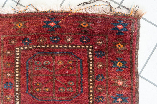 Close-up of geometric octagonal medallion patterns on a 1950s Afghan rug