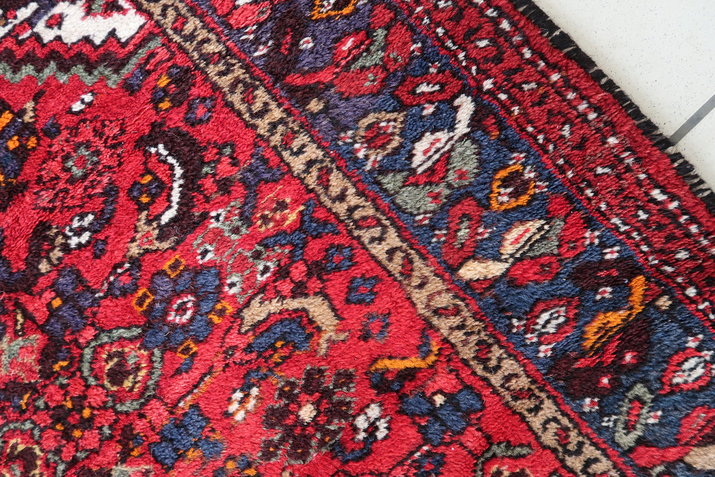 Decorative Persian wool rug with vibrant colors and intricate patterns